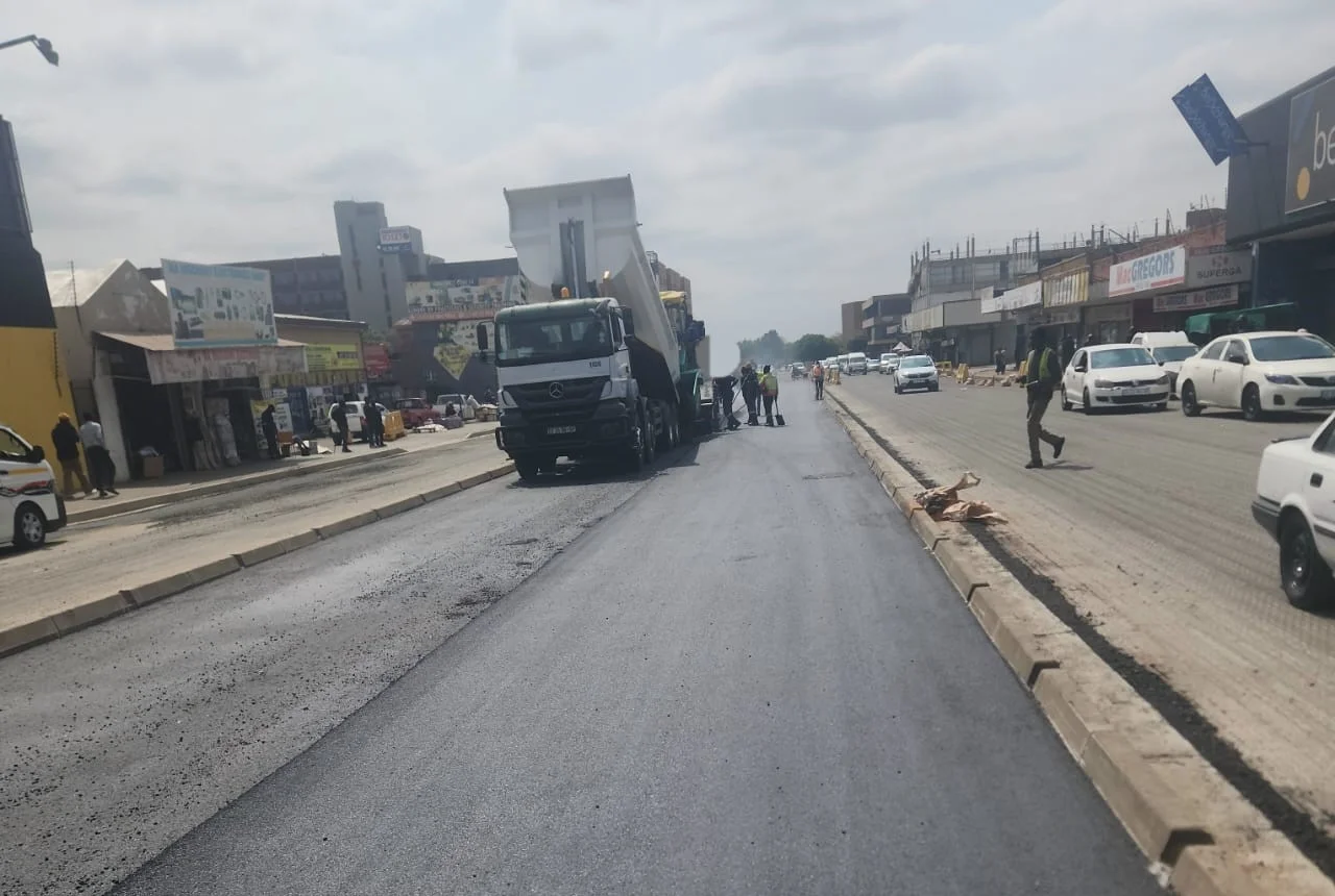Paving equipment laying asphalt on an urban road